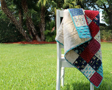 Load image into Gallery viewer, Beachy Reds and Blues Baby Quilt
